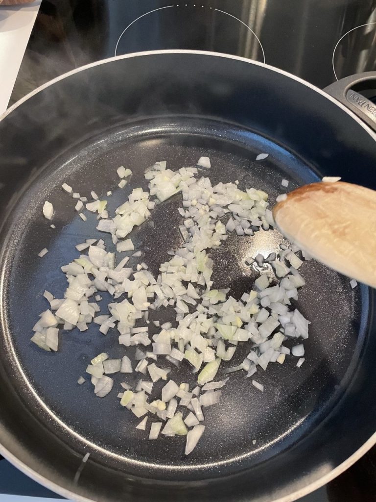 Sautee garlic and onions for Goop's Broccoli & Arugula Soup